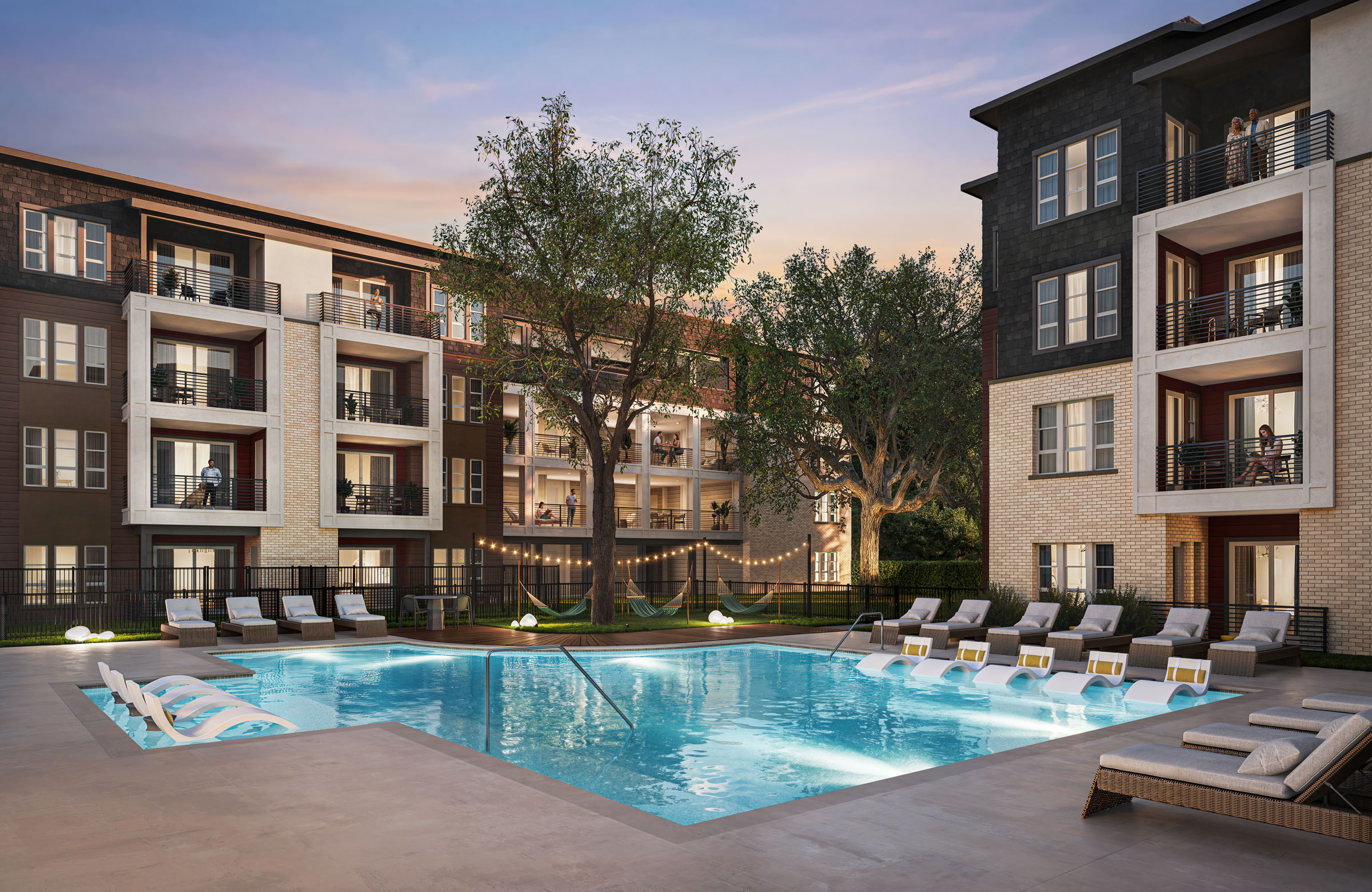 Multifamily courtyard pool with lounge chairs and apartment balconies.