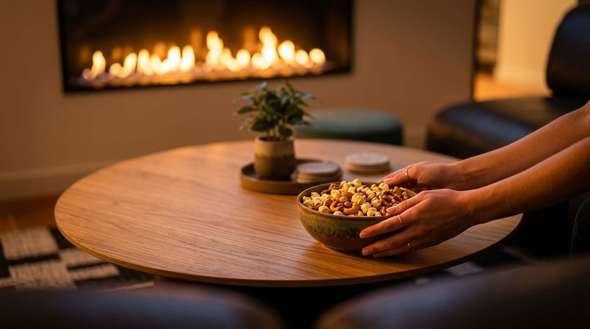 Popcorn bowl on a coffee table in a cozy fire-lit lounge.