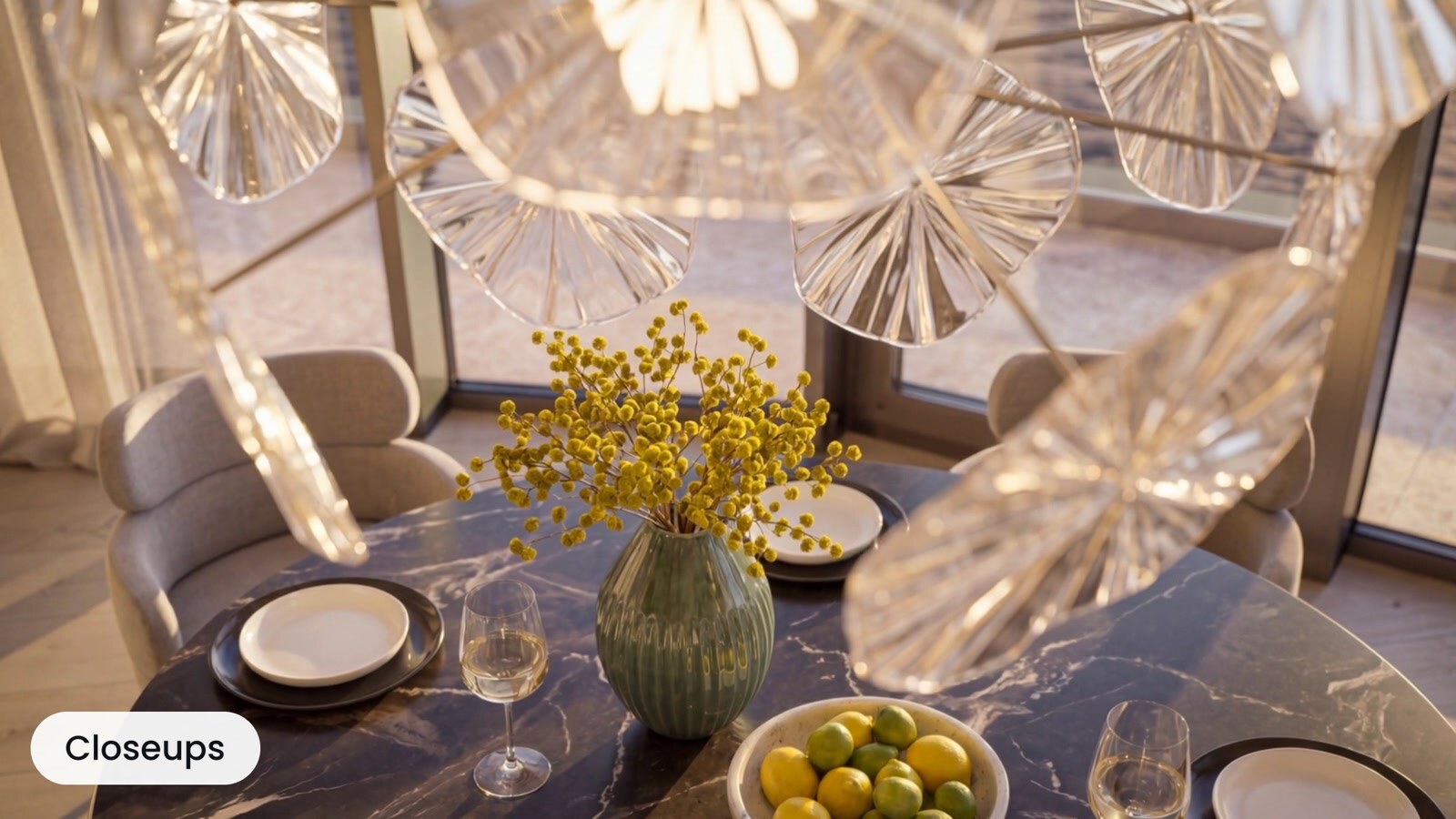Styled dining table with glassware, flowers, and fresh fruit