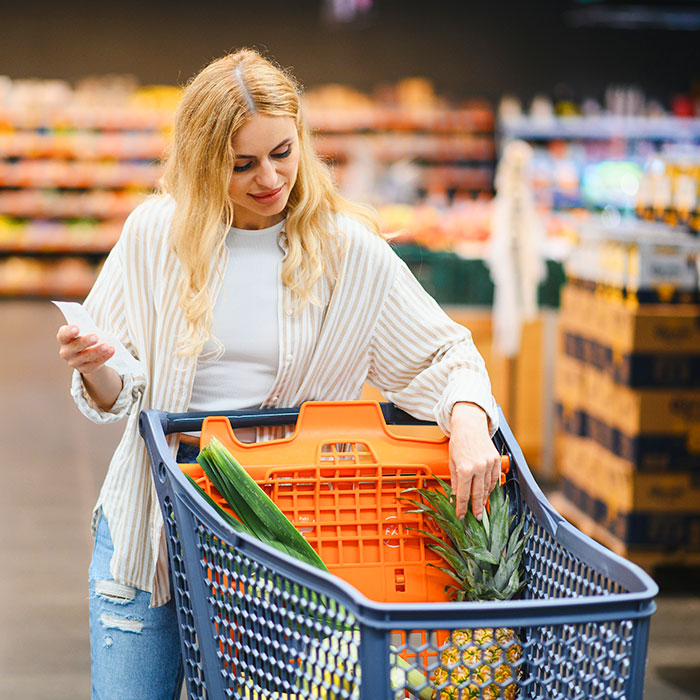 Woman grocery shopping with a full cart for Orderly pickup and delivery service in Ocean City, NJ