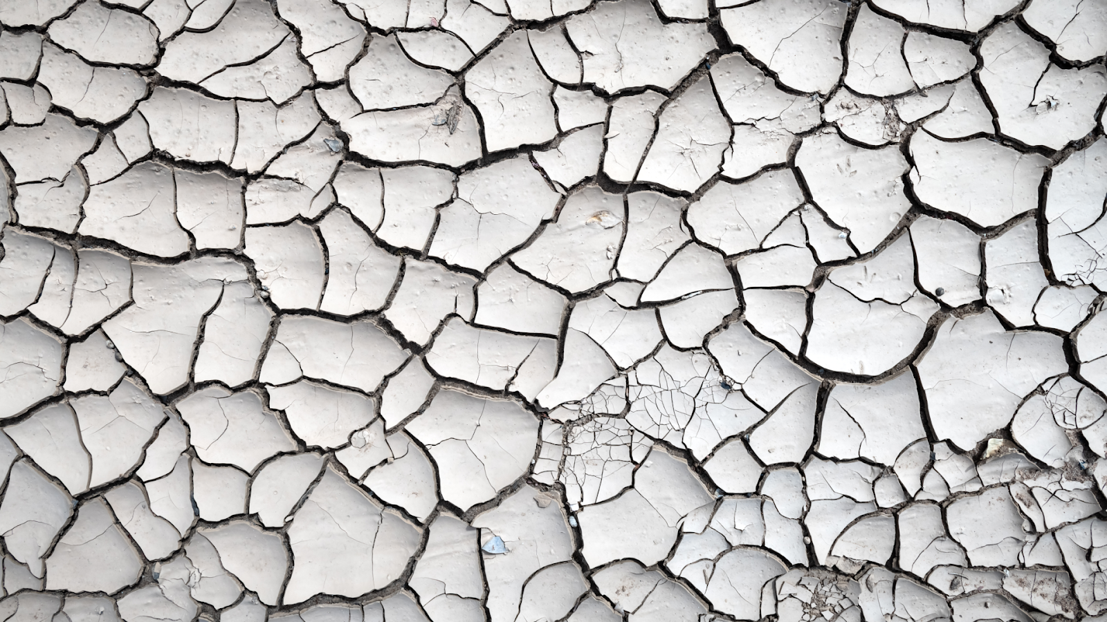 Uma superfície rachada representando falta de humidade, servindo como metáfora para a falta de liquidez na negociação