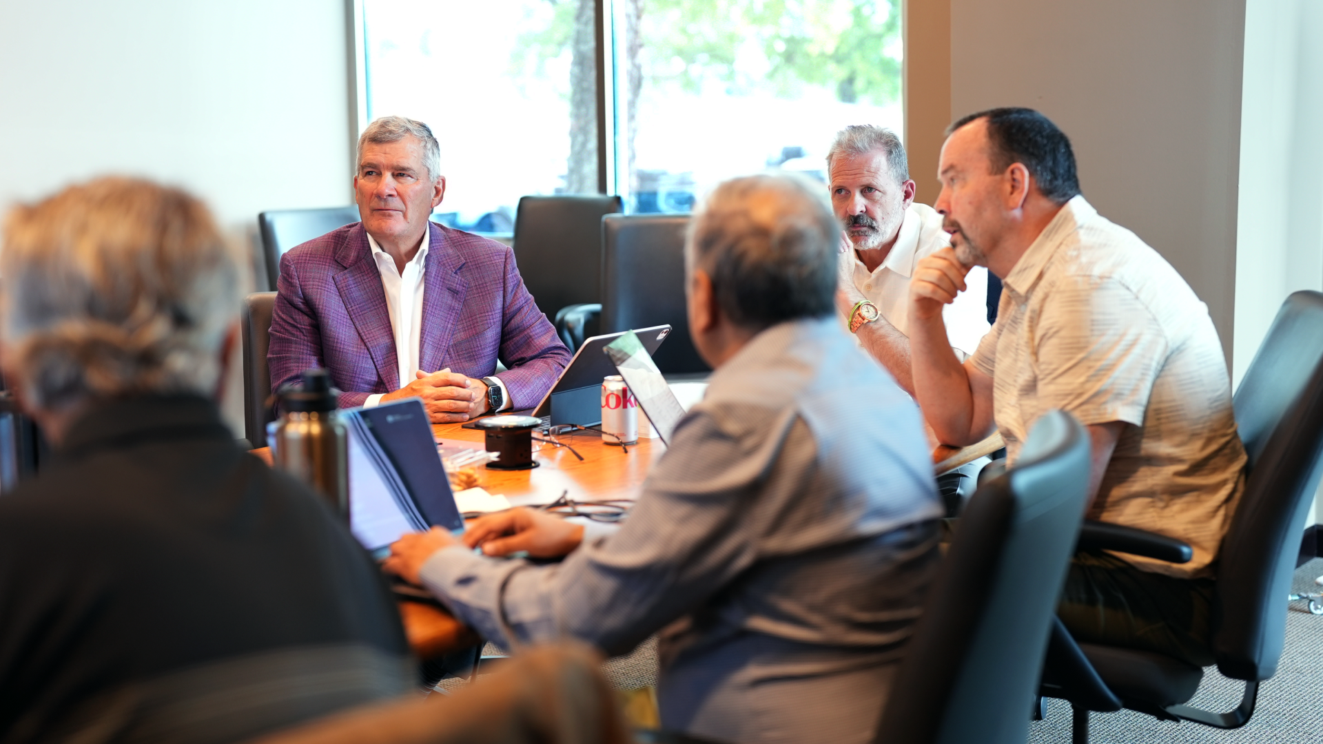 Arrive AI C-suite team members - Todd, Dan, Neerav and Mark collaborating around a conference table