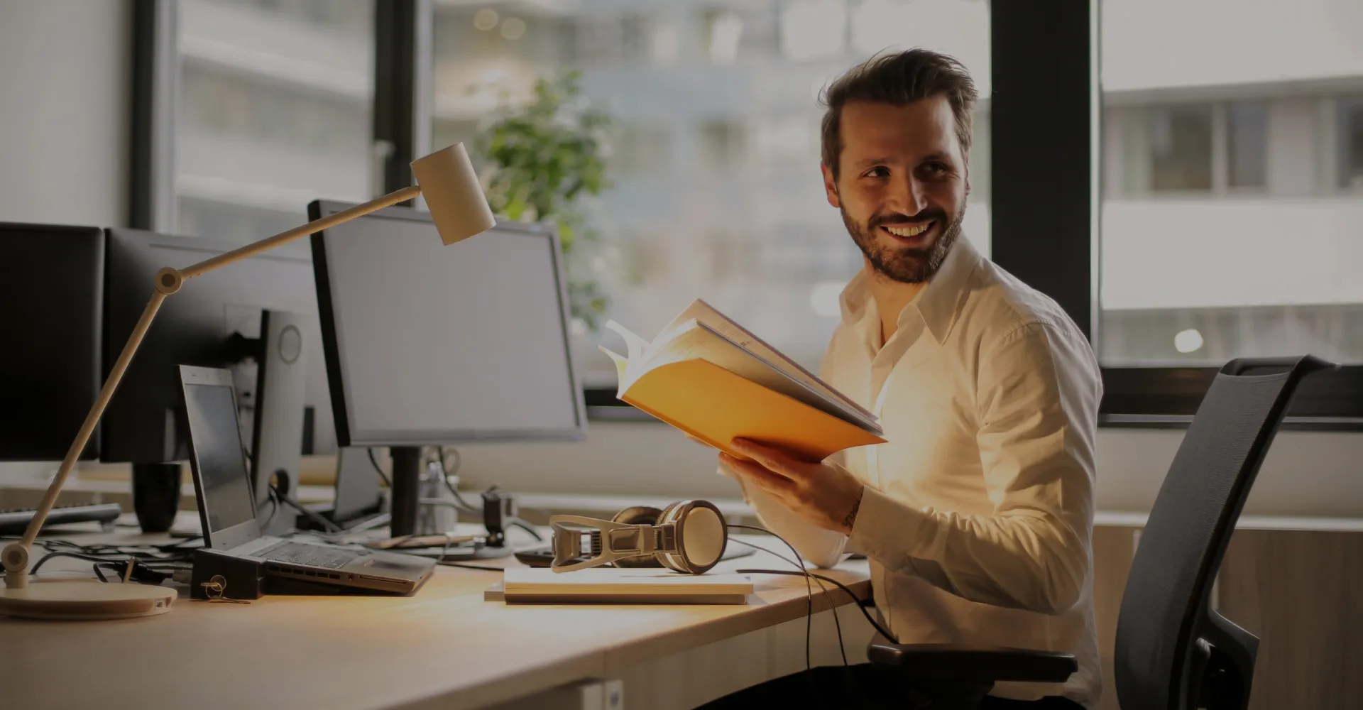 A man at his desk, focused on work in an office environment.