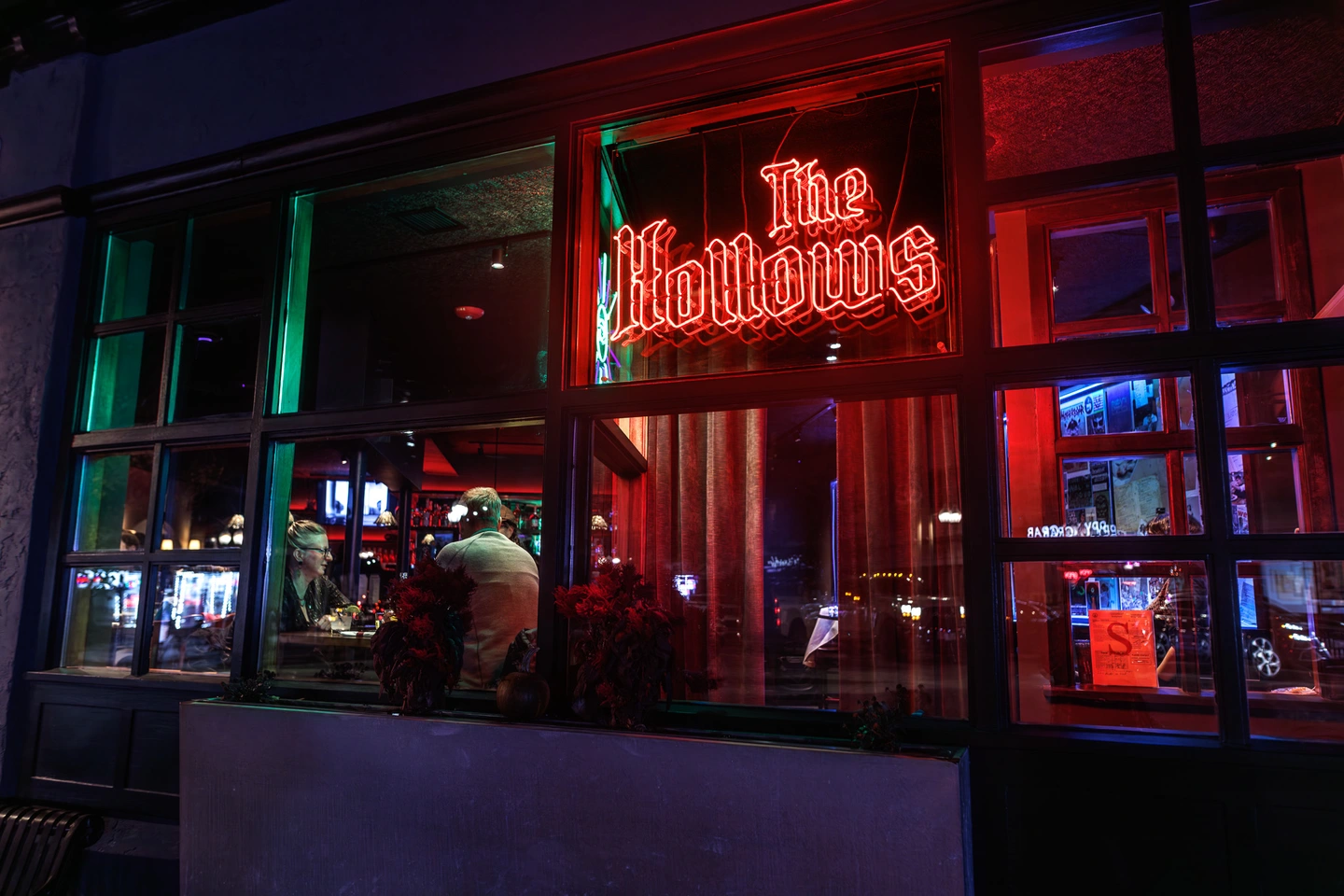 Red neon light sign of "The Hollows"