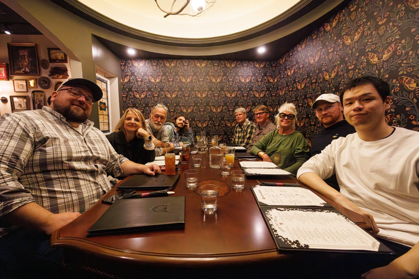 Group of customers in the Den, smiling for a photo