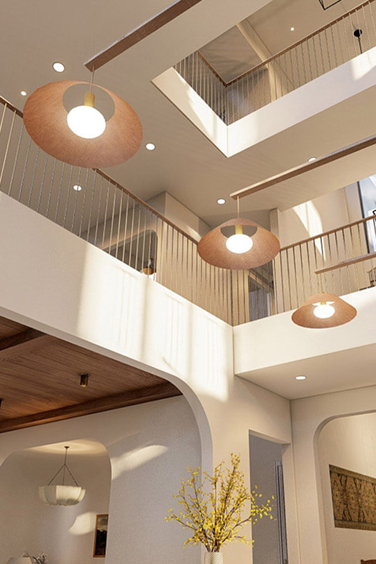 Photo of a kitchen table with three modern lights overhead; camera is pointed slightly upwards