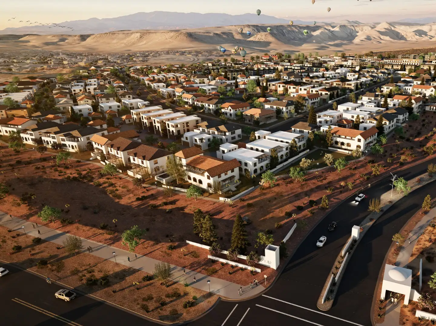 Aerial rendering of a planned desert residential community with winding roads, white and terracotta homes, and hot air balloons in the sky.