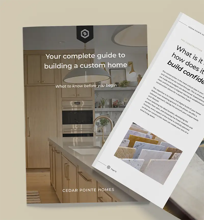 Printed Cedar Pointe Homes booklet titled "Your complete guide to building a custom home," shown with an interior page.