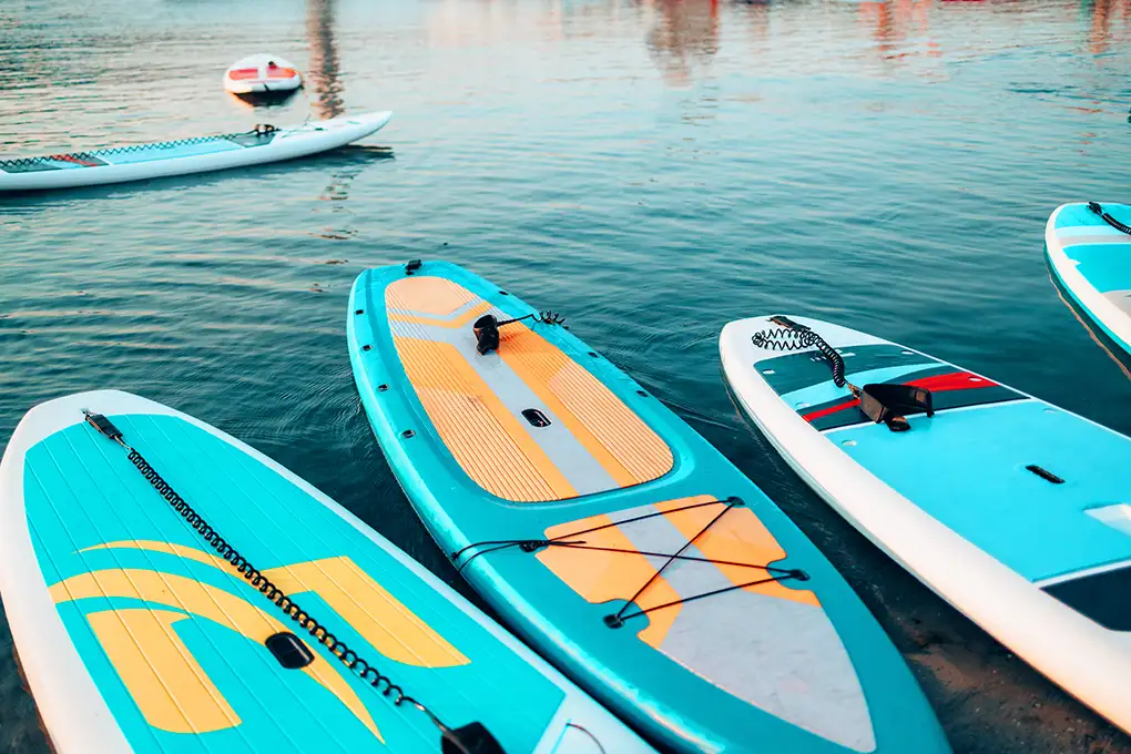Colorful paddleboards floating on calm water