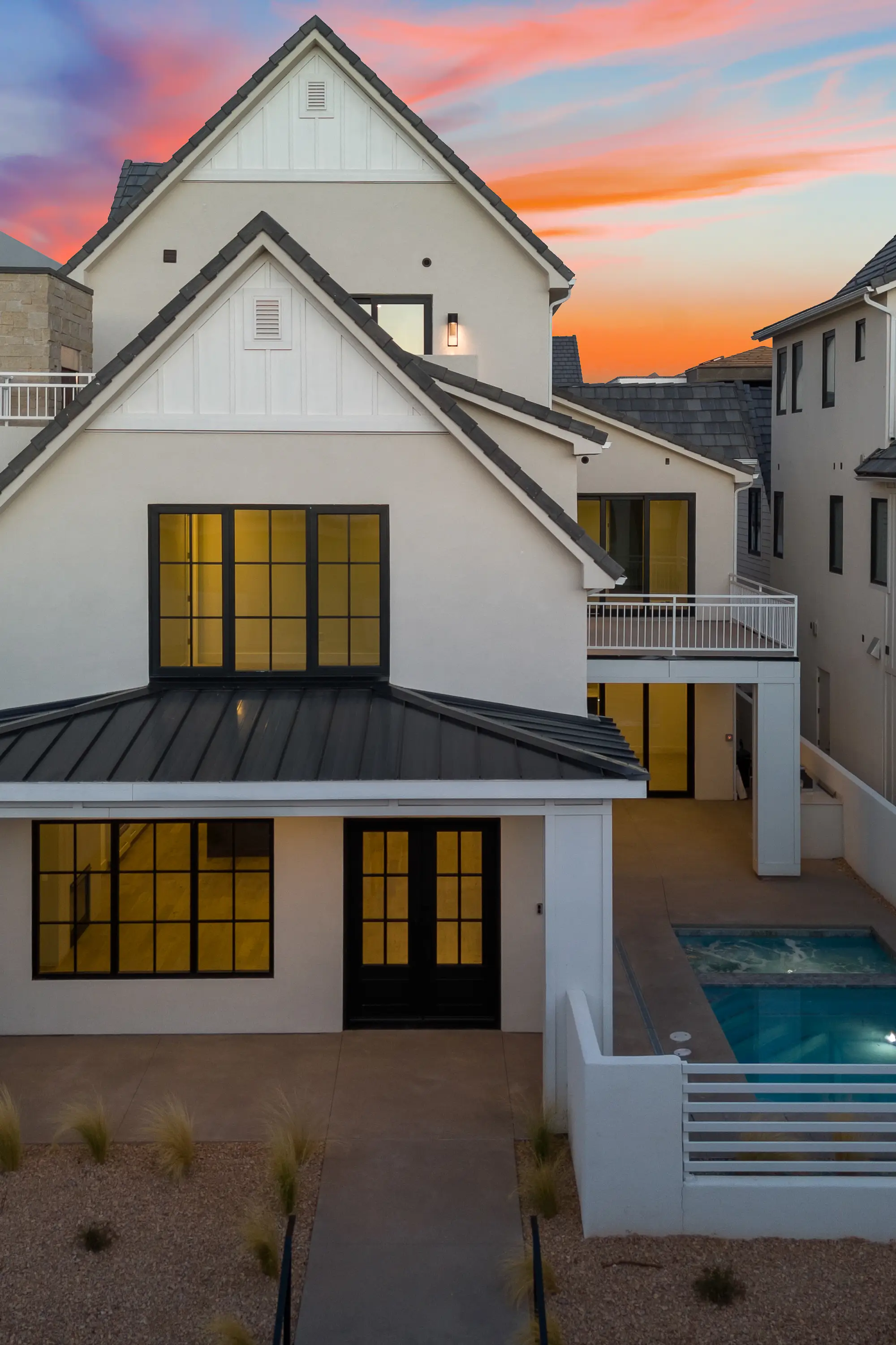 Desert Solace backyard with plunge pool, covered patio, and vibrant desert sunset sky