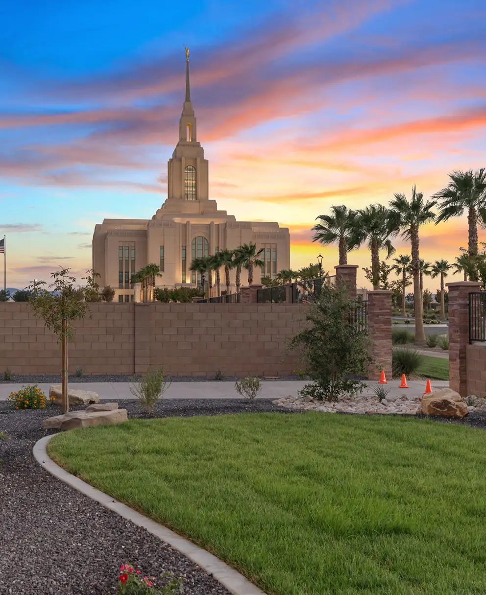 Summit View backyard with green lawn and temple silhouette against a colorful desert sunset