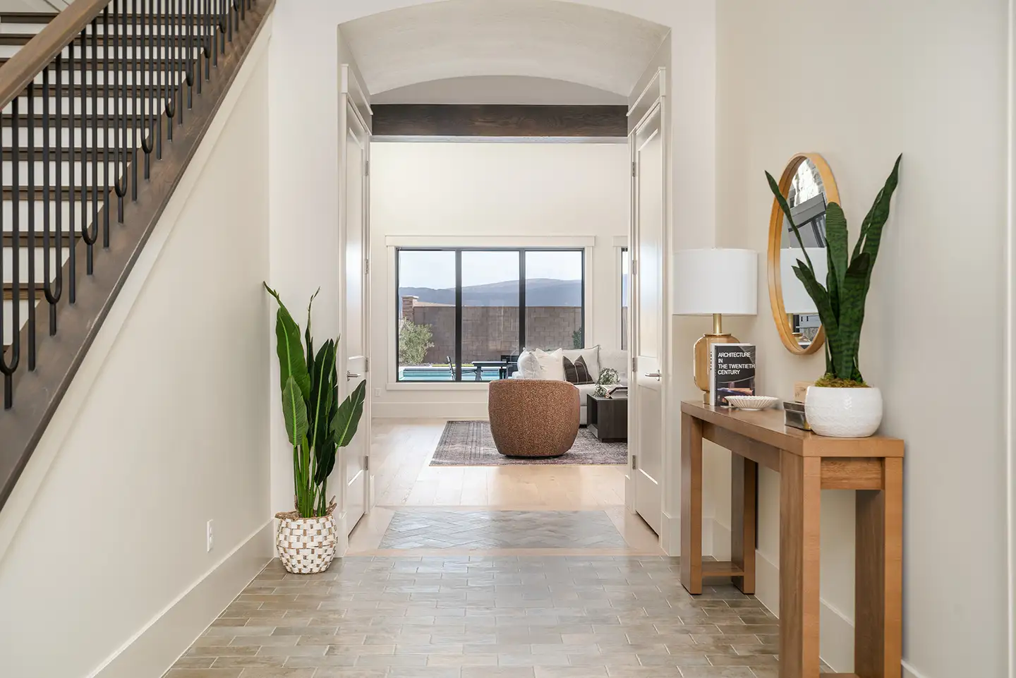 Villa Bellrose foyer with arched doorway, staircase, and view through to pool and mountains