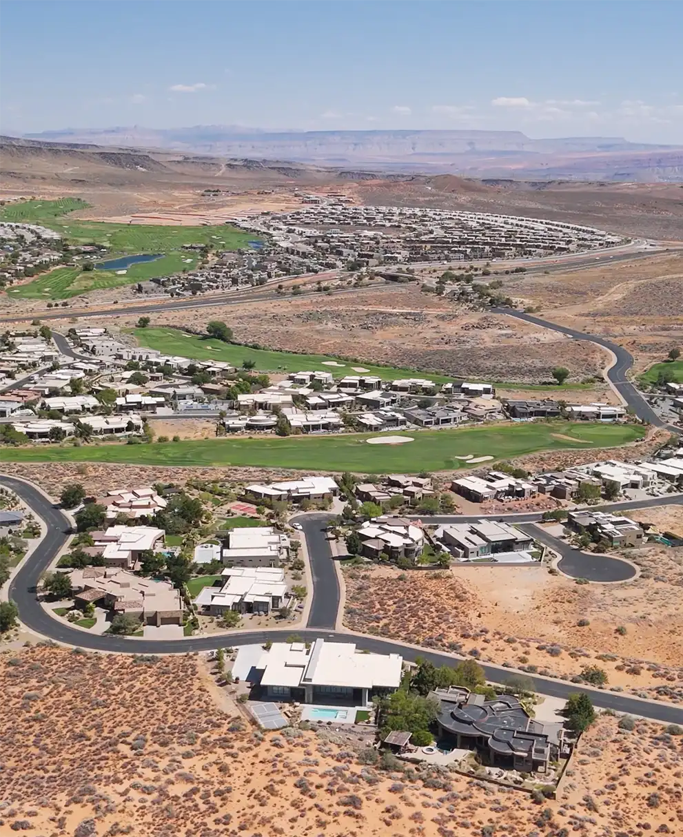 Aerial view of a sprawling desert residential community with winding roads and mountain views