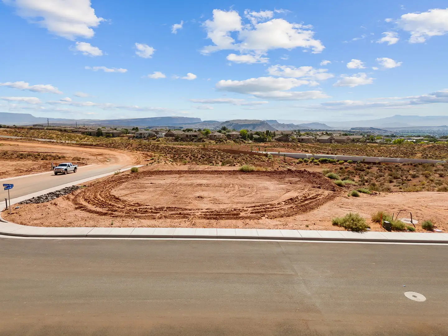 Street-level view of a graded cul-de-sac home lot with sweeping mountain and mesa views on the horizon