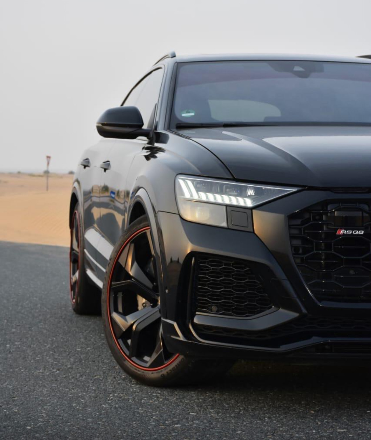Black Audi RS Q8 SUV with sleek design and red-rimmed wheels