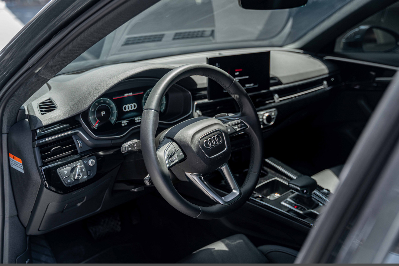 Interior of a modern Audi with digital dashboard and steering wheel