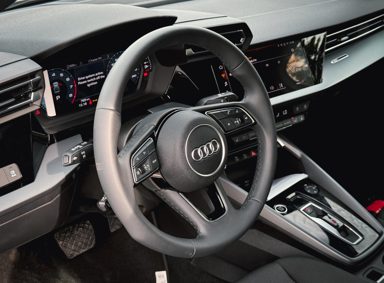 Interior of modern Audi car with steering wheel and digital dashboard