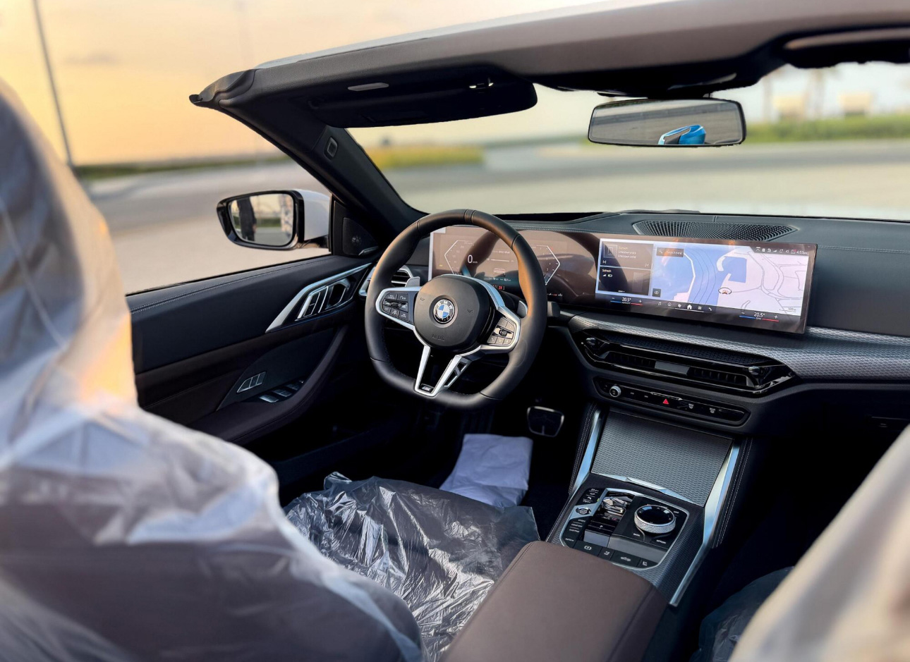 BMW interior with digital dashboard and protective plastic cover