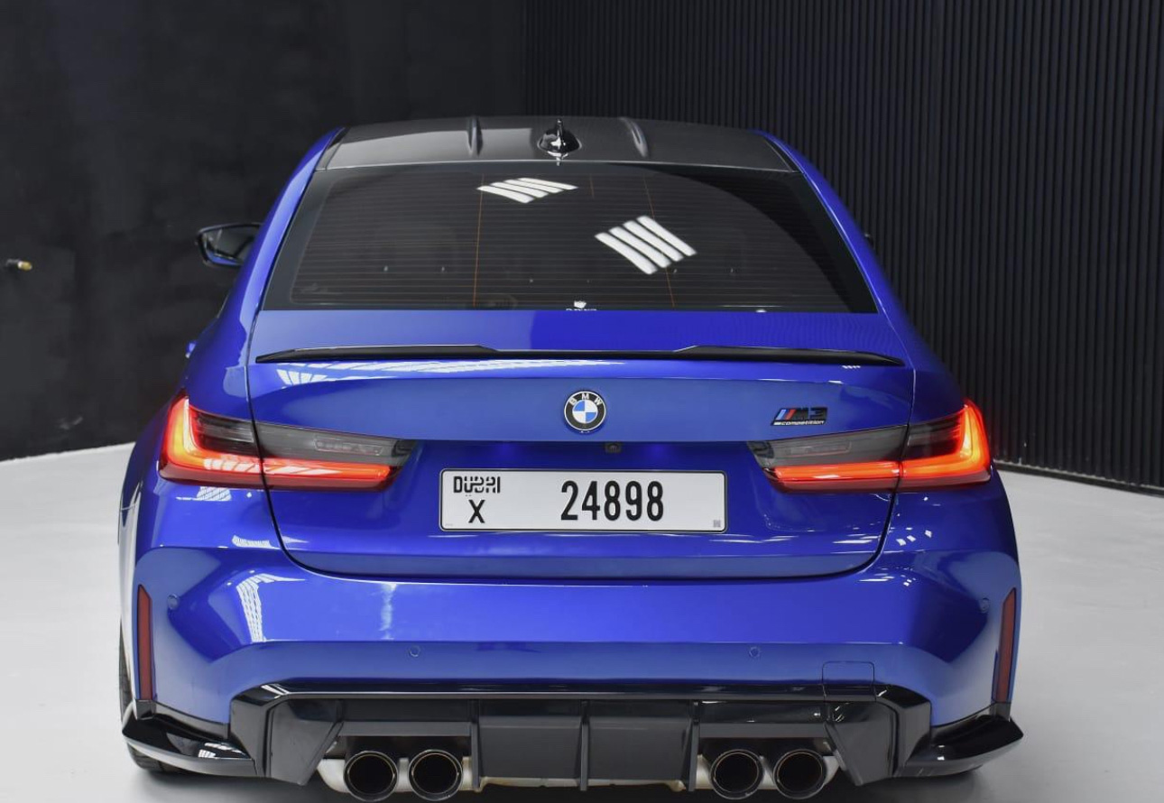 Blue BMW M3 sports car rear view with quad exhaust
