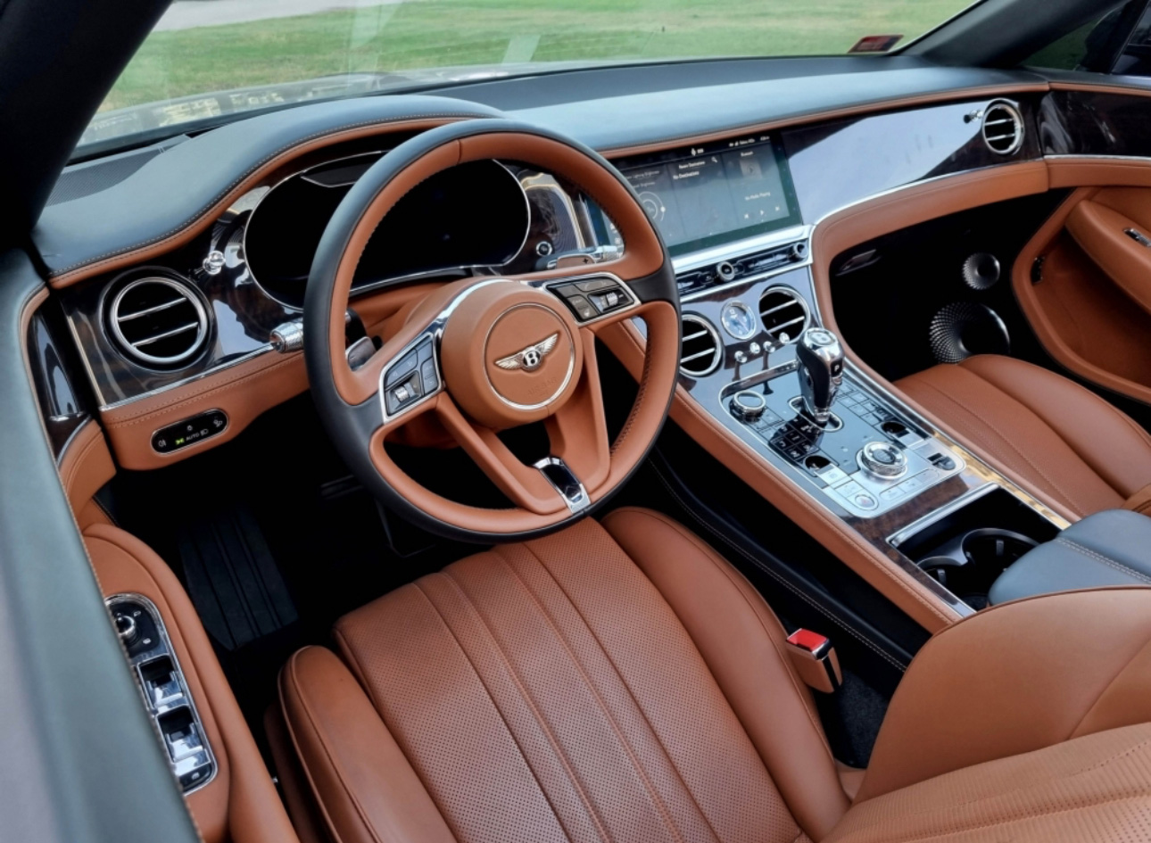 Luxurious Bentley interior with tan leather and modern digital dashboard