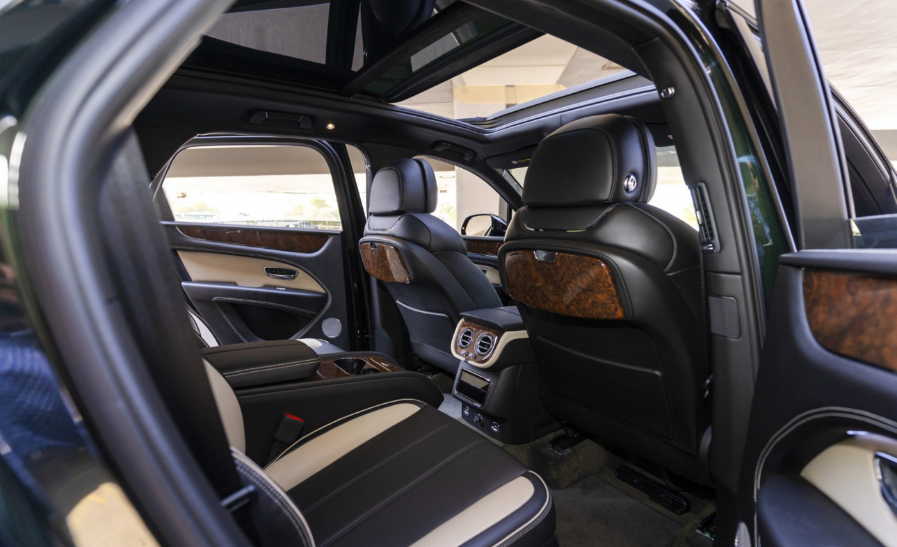 Luxurious car interior with black and white leather seats, panoramic roof