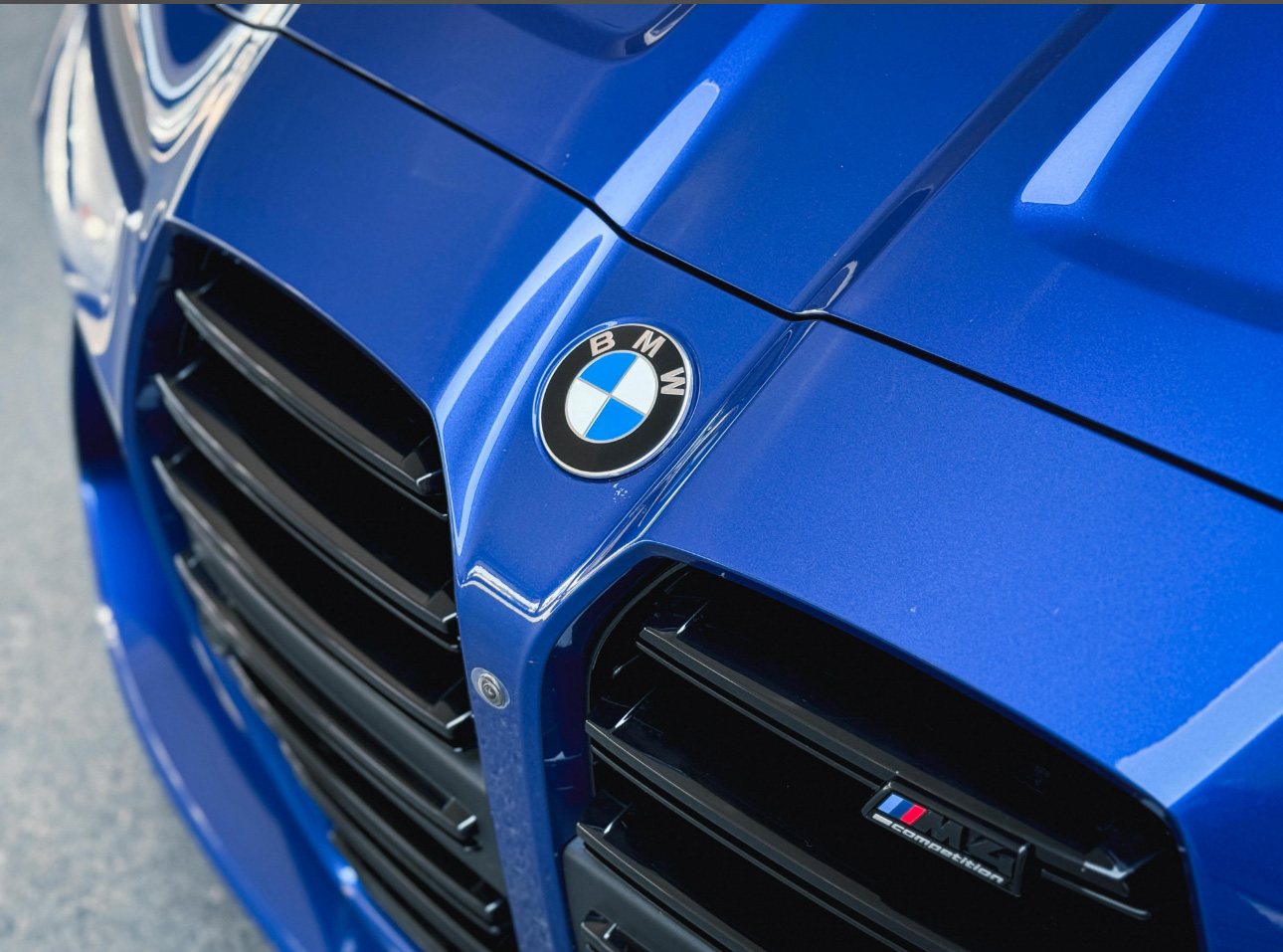 Close-up of blue BMW car with grille and BMW logo