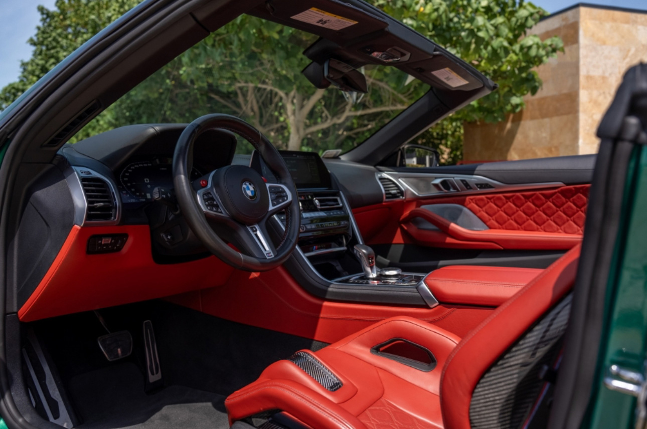 Green BMW interior with red leather seats and modern dashboard