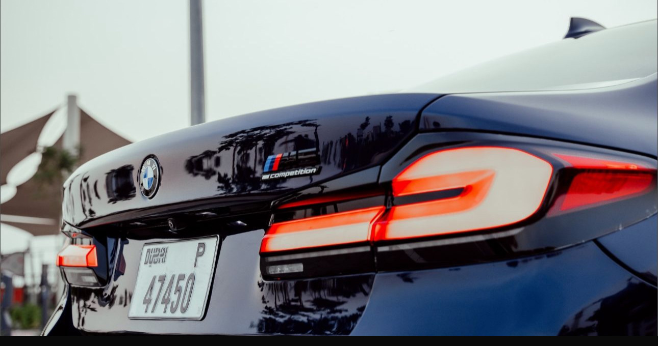 BMW M Competition car rear view with glowing taillights