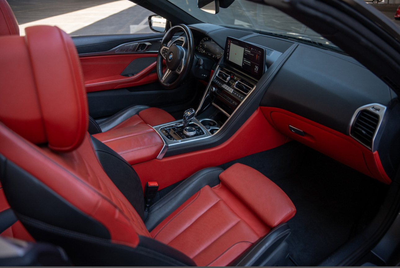 BMW interior with red leather seats and modern dashboard design