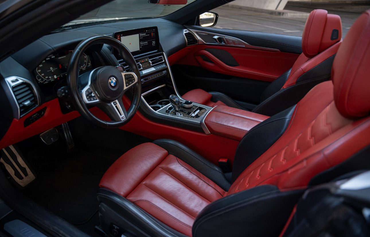 BMW interior with red leather seats and modern dashboard design