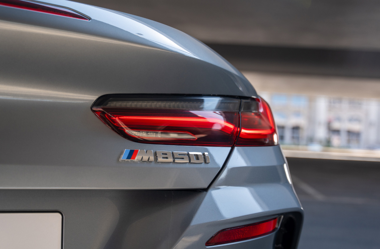 BMW M850i tail light and model badge on silver luxury coupe