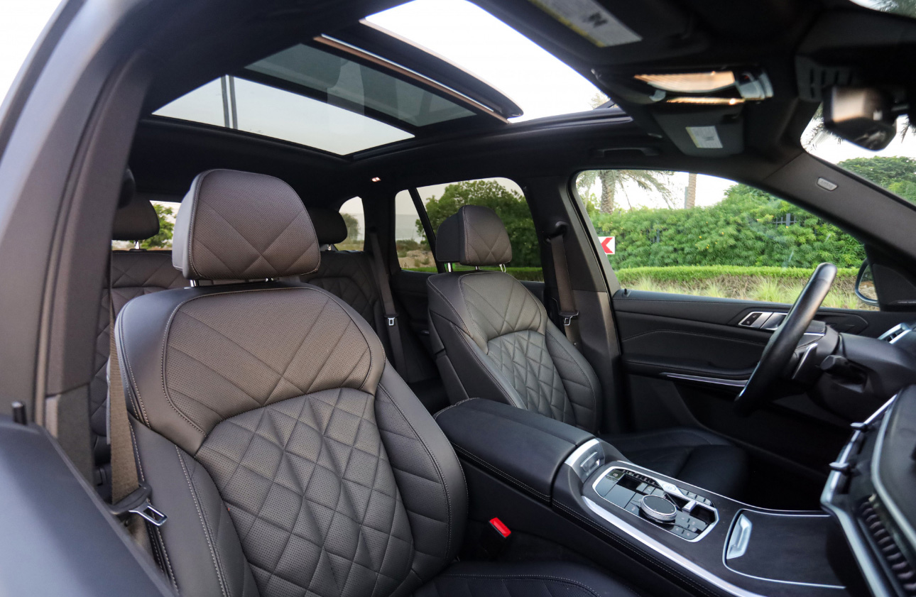 Luxurious car interior with quilted leather seats and panoramic sunroof
