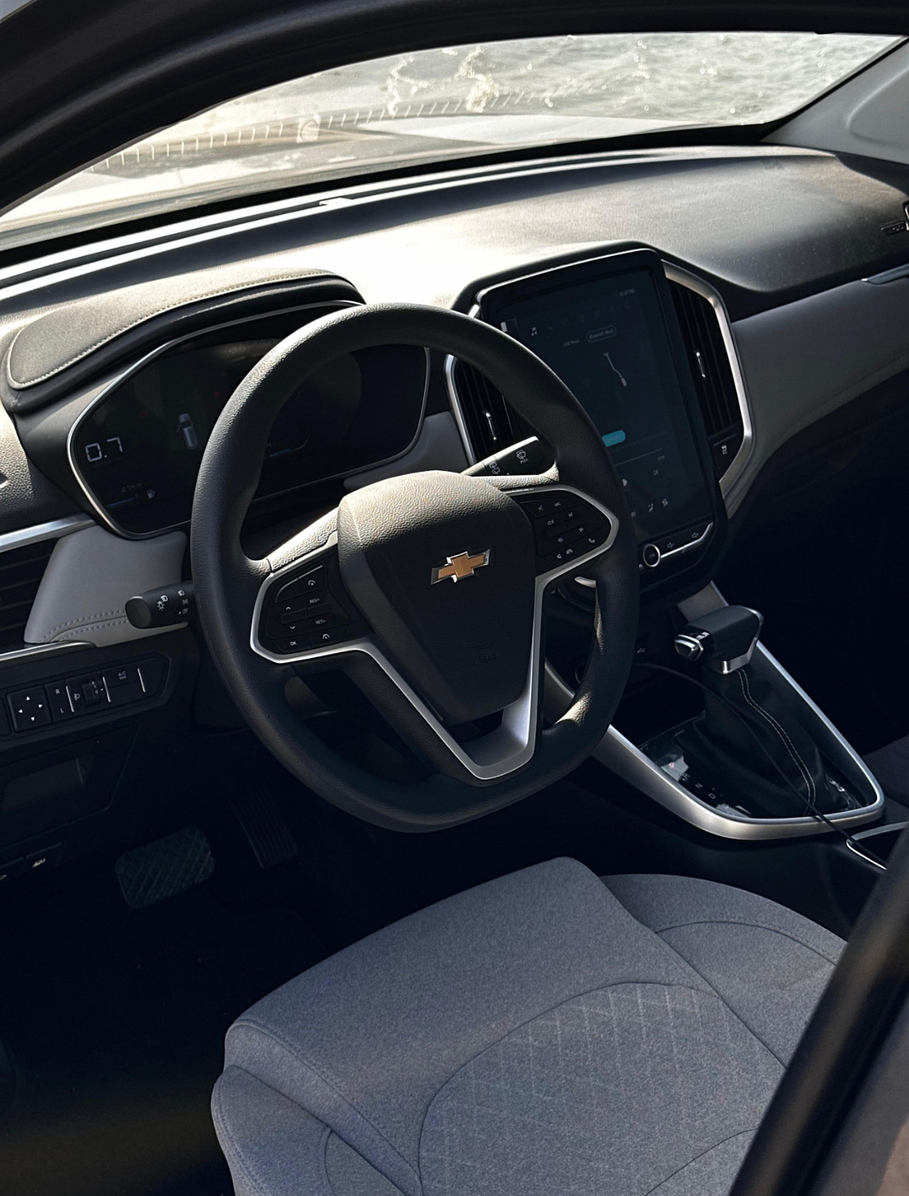 Interior of Chevrolet car with digital dashboard and gray fabric seats