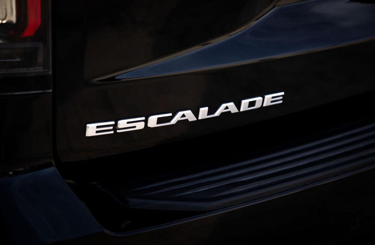 Close-up of Escalade logo on black SUV side panel