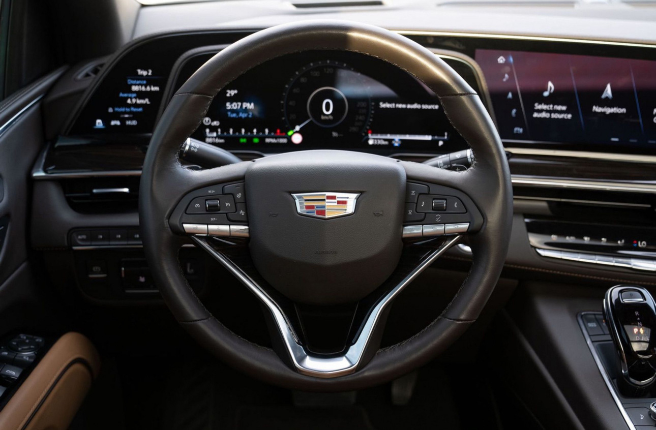 Cadillac steering wheel with digital dashboard displaying vehicle information