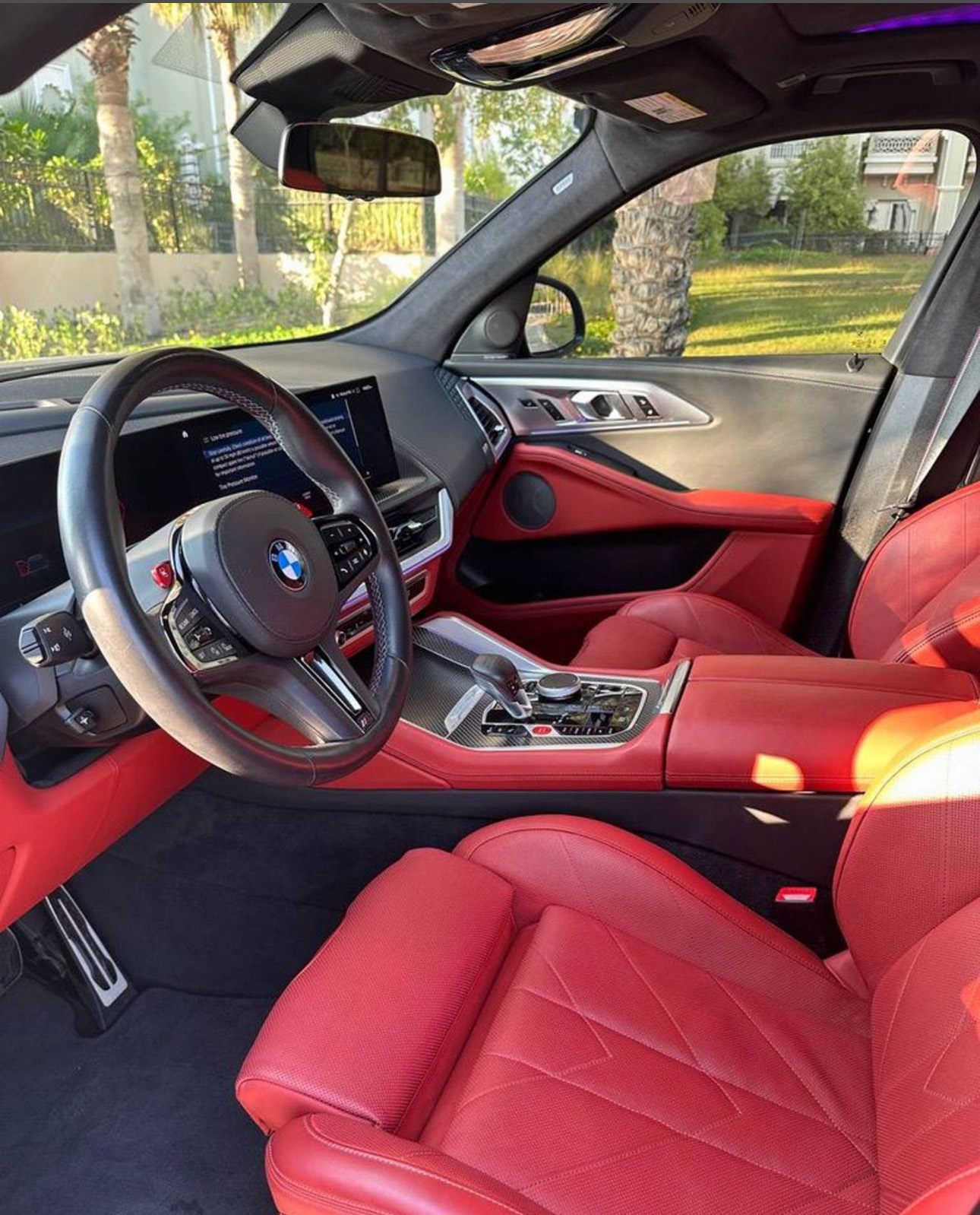 BMW interior with red leather seats and modern dashboard design