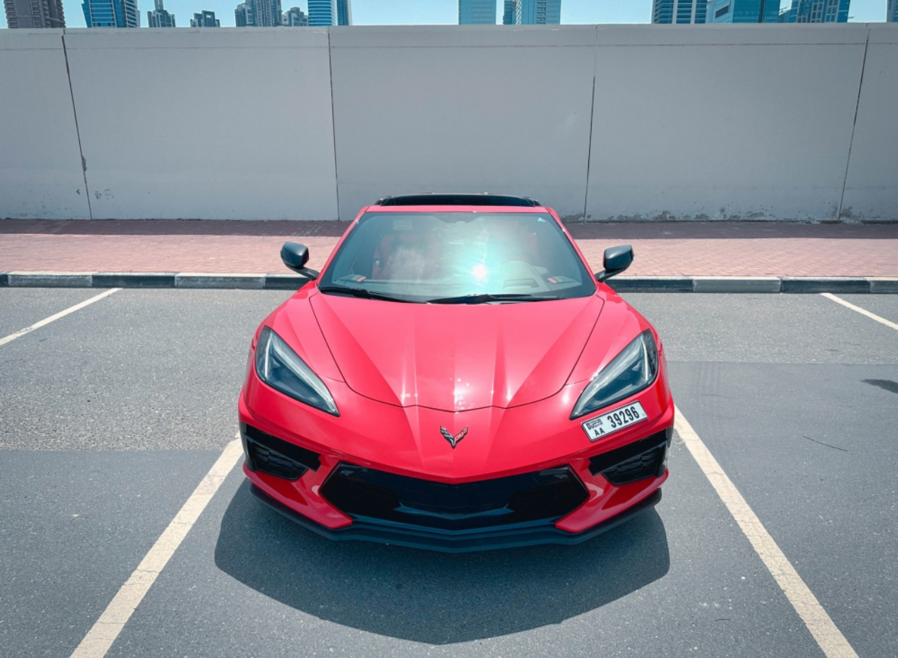 Bright red Corvette sports car parked in urban parking lot