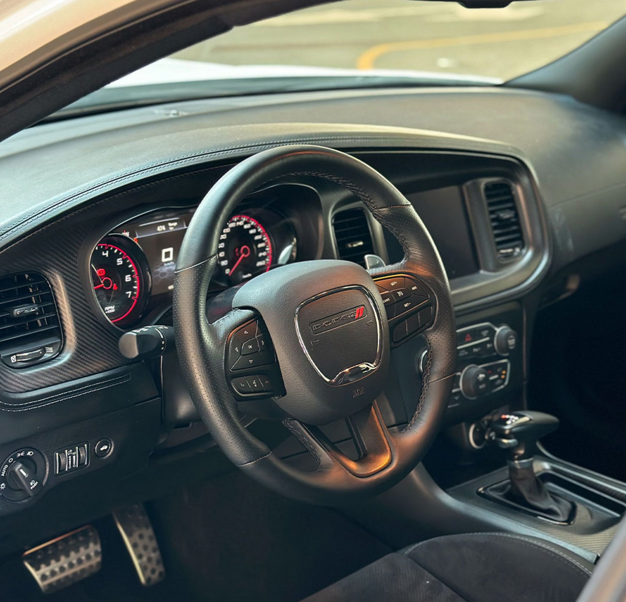Interior of a Dodge vehicle with steering wheel and dashboard instruments