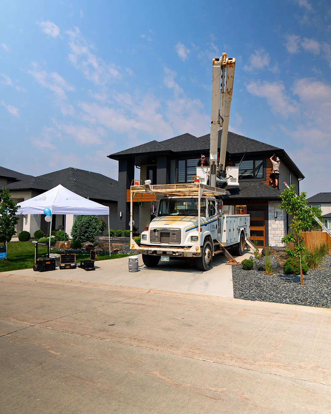 Crew installing lights on home