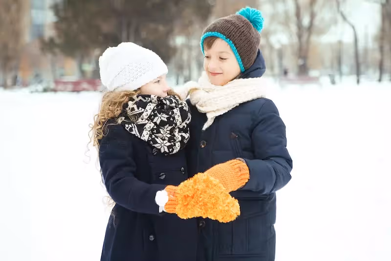 Two childrens are wearing winter jackets