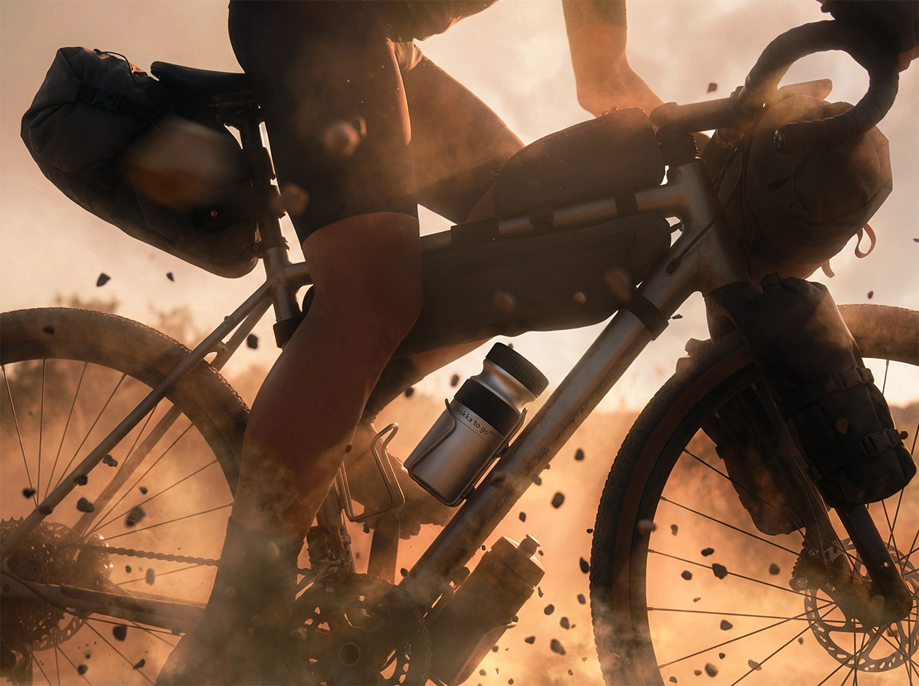 A man on a gravel bike with the mokka to go in a cupholder