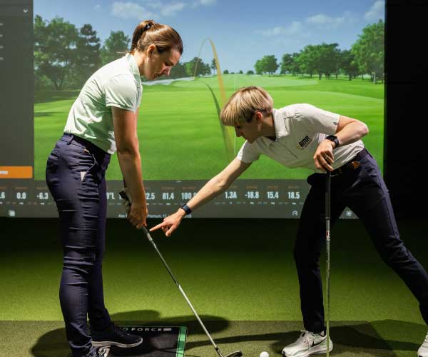 Leaner golfer being instructed