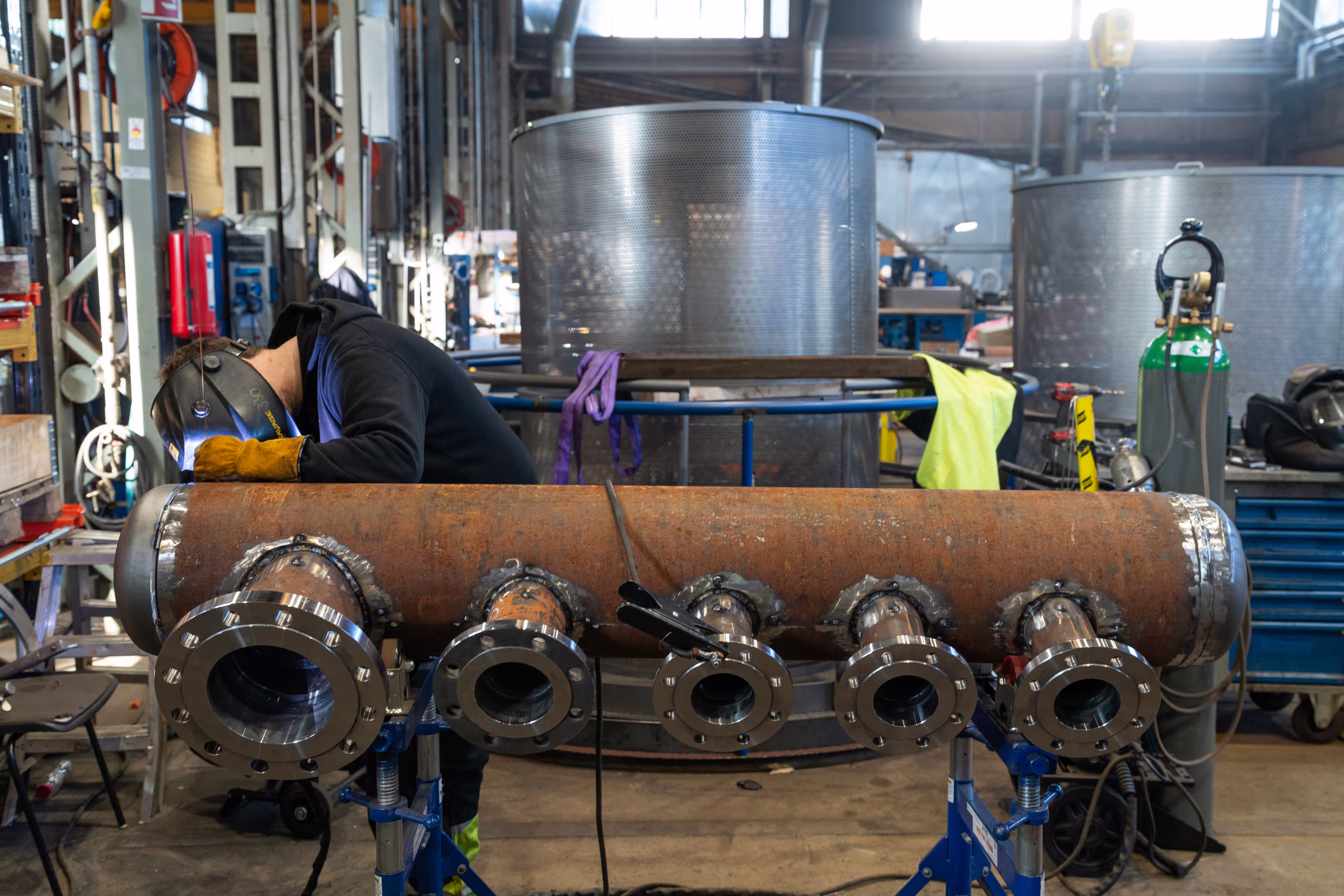 Parat workshop. Welder working on a component for a boiler.