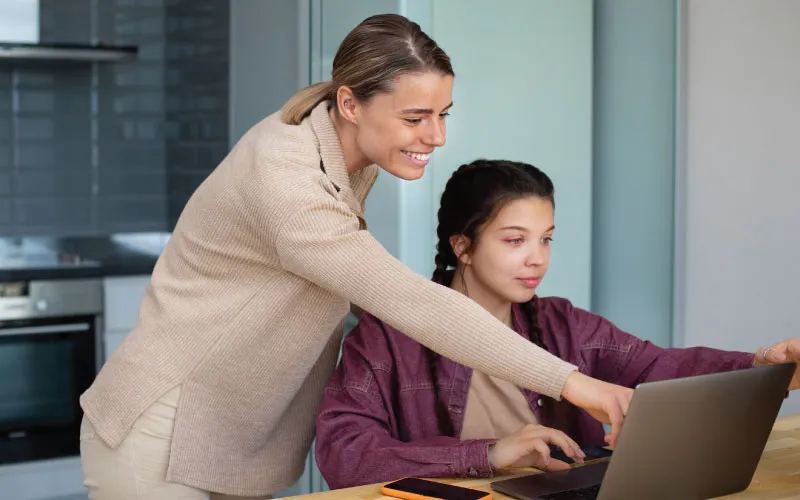 Teacher helping student