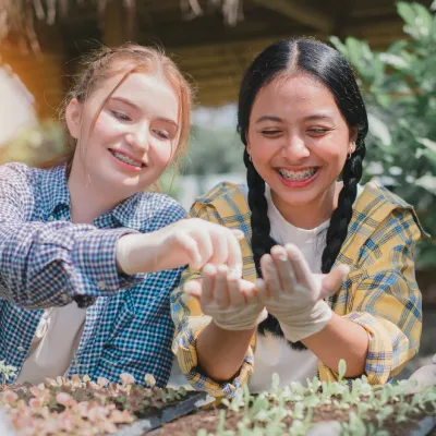 Young student girls gardening