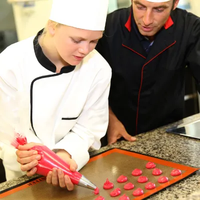 Young student being taught patisserie skills
