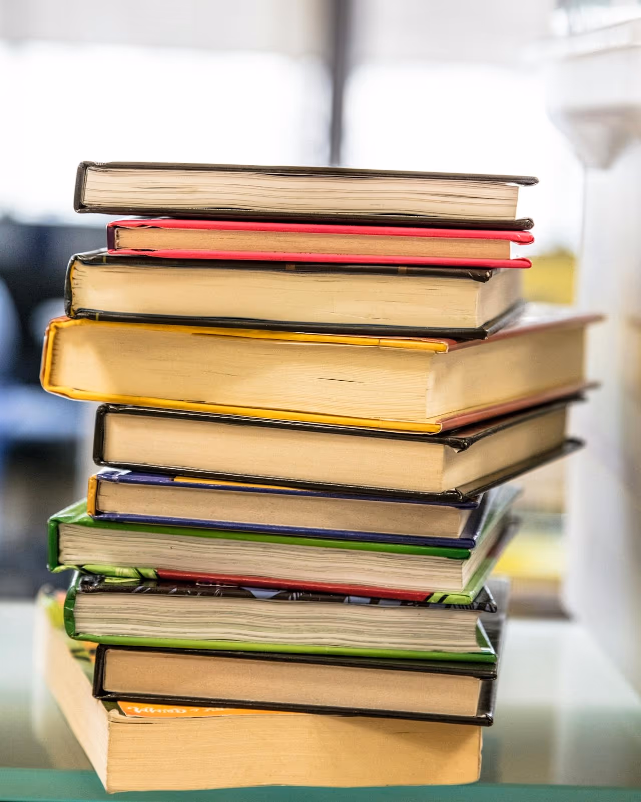 A pile of books on a table. 