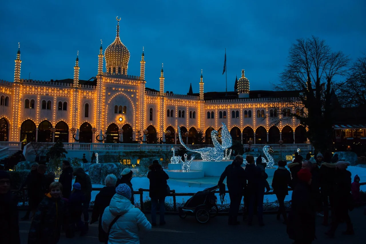 Moorish-style facade of Nimb Hotel Copenhagen illuminated with golden Christmas lights at dusk