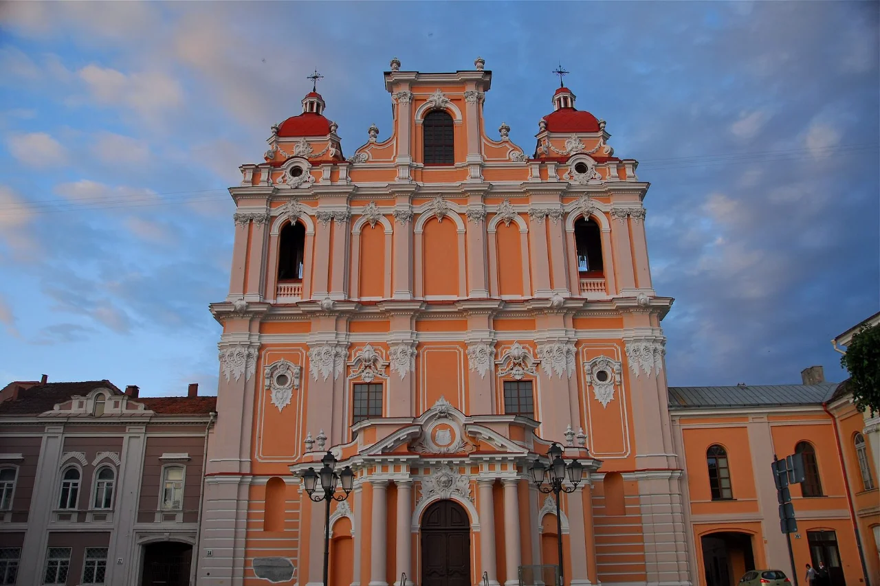 Baroque St. Casimir Church with ornate coral and white facade in the old town of Vilnius, Lithuania