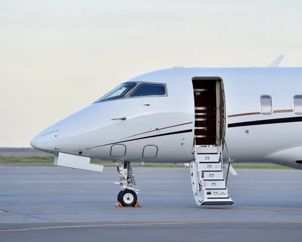 Privatjet auf dem Vorfeld geparkt, mit geöffneter Kabinentür und heruntergelassener Treppe